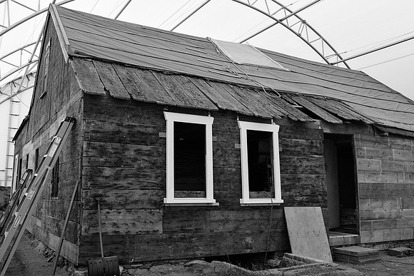 Exterior under restoration under temporary enclosure.