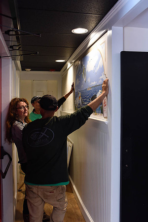 Opening day, May 29, 2015: Artist Margot Datz supervising  the hanging of her lobby paintings.