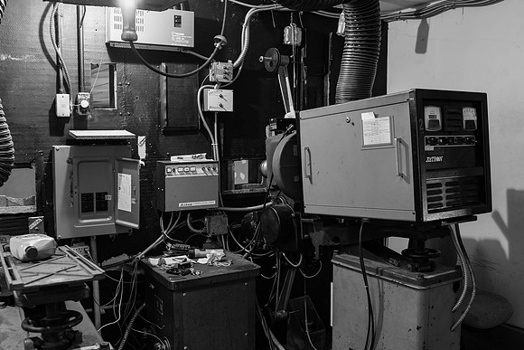 The projection room at the start of renovation works with old film projector. (April 21, 2015)